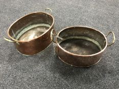 Two graduated antique copper brass handled pans
