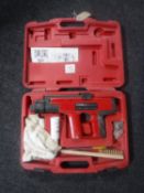 A cased FM900/2 powder actuated tool (nail gun)