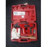 A cased FM900/2 powder actuated tool (nail gun)