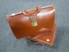 A vintage leather briefcase and a suitcase