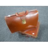 A vintage leather briefcase and a suitcase