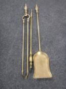 A three-piece early 20th century brass companion set
