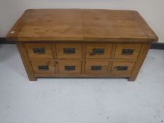 An oak storage coffee table fitted with drawers beneath