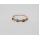 An 18ct gold emerald and diamond set half-eternity ring,