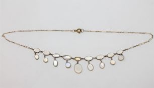 A moonstone necklace on yellow metal chain