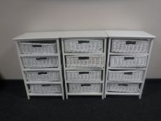 Three painted four drawer chests with wicker drawers