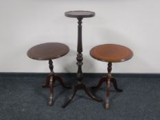 A mahogany torchere and pair of wine tables