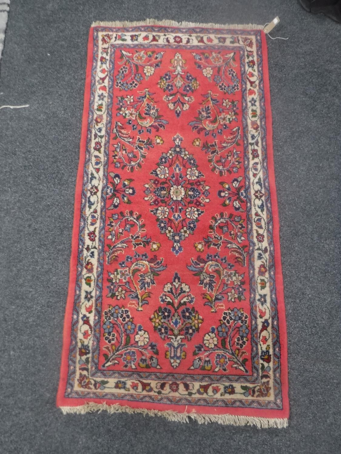 A fringed Iranian Saroukh rug on salmon ground