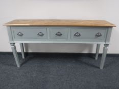 A painted three drawer console table with parquet panel top