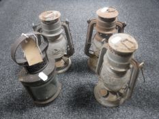 A vintage railway lamp and three Tilley lamps