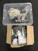 A box of new and used chrome and plastic car badges and letters