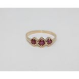 A 9ct gold three stone ruby ring,