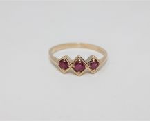A 9ct gold three stone ruby ring,