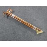 A bundle of 20th century walking sticks and a brass headed candle snuffer