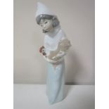 A Lladro figure of a girl in cloak carrying a hen,