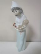 A Lladro figure of a girl in cloak carrying a hen,