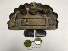 An ornate copper desk stand and a set of vintage spectacles in case