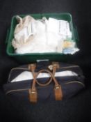 A crate and a holdall of vintage table linen