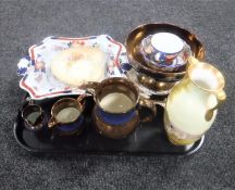 A tray containing antique china to include copper lustre bowl and two graduated jugs,