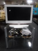 A Samsung 22 inch LCD TV on stand with remote and a Goodmans digital TV receiver plus assorted