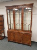 A reproduction glazed mahogany display cabinet fitted three drawers beneath,