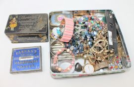 A tin containing two silver napkin rings, costume jewellery, cigarette case, trinket boxes,