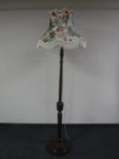 An early 20th century carved beech standard lamp with shade