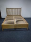 A contemporary oak 5' rail bed frame