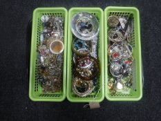 A tray of three small baskets of assorted costume jewellery