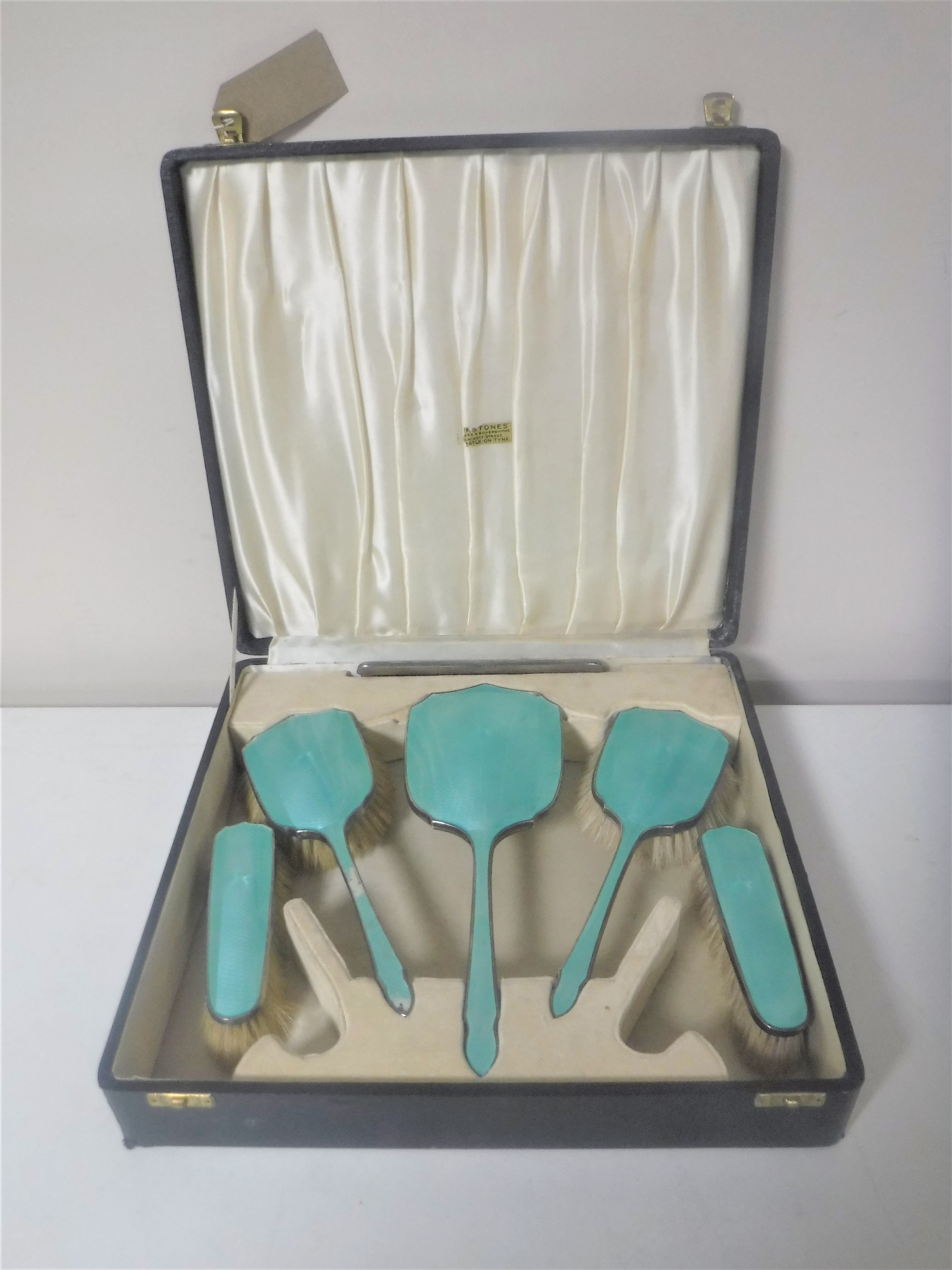 A cased Art Deco five-piece silver and enamel dressing table brush set,