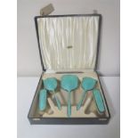 A cased Art Deco five-piece silver and enamel dressing table brush set,