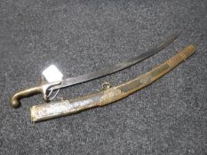A 20th century eastern miniature Mamluk sword in embossed brass and leather scabbard