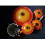 Five pieces of Le Cruset ware - wok with lid, fondue dish on stand,