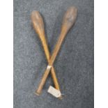 A pair of vintage wooden throwing/juggling clubs