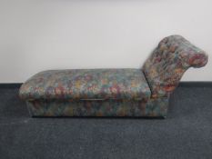 An early 20th century storage chaise longue in button fabric