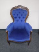 A Victorian style lady's armchair in blue buttoned fabric