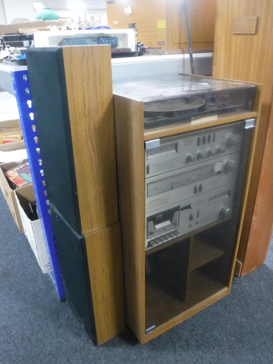 An Amstrad hi/fi in cabinet with speakers