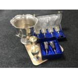 A tray of plated ice buckets and eight goblets