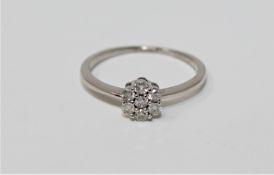 An 18ct white gold seven-stone diamond cluster ring,