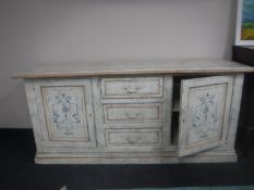 A painted sideboard fitted three drawers and two cupboards