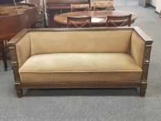 A late 19th/early 20th century continental oak settee upholstered in olive dralon,