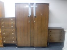 Three pieces of mid 20th century teak bedroom furniture comprising of double door wardrobe,