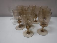 A tray of twelve antique hand blown swirl pattern glasses and two further glasses
