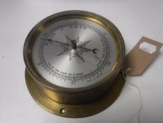 A circular brass ship's barometer