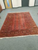An Afghan Bokhara carpet on terracotta ground,