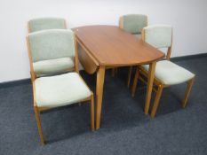 A 1970's teak drop leaf table together with four chairs