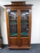 A late 19th century continental mahogany double door glazed bookcase
