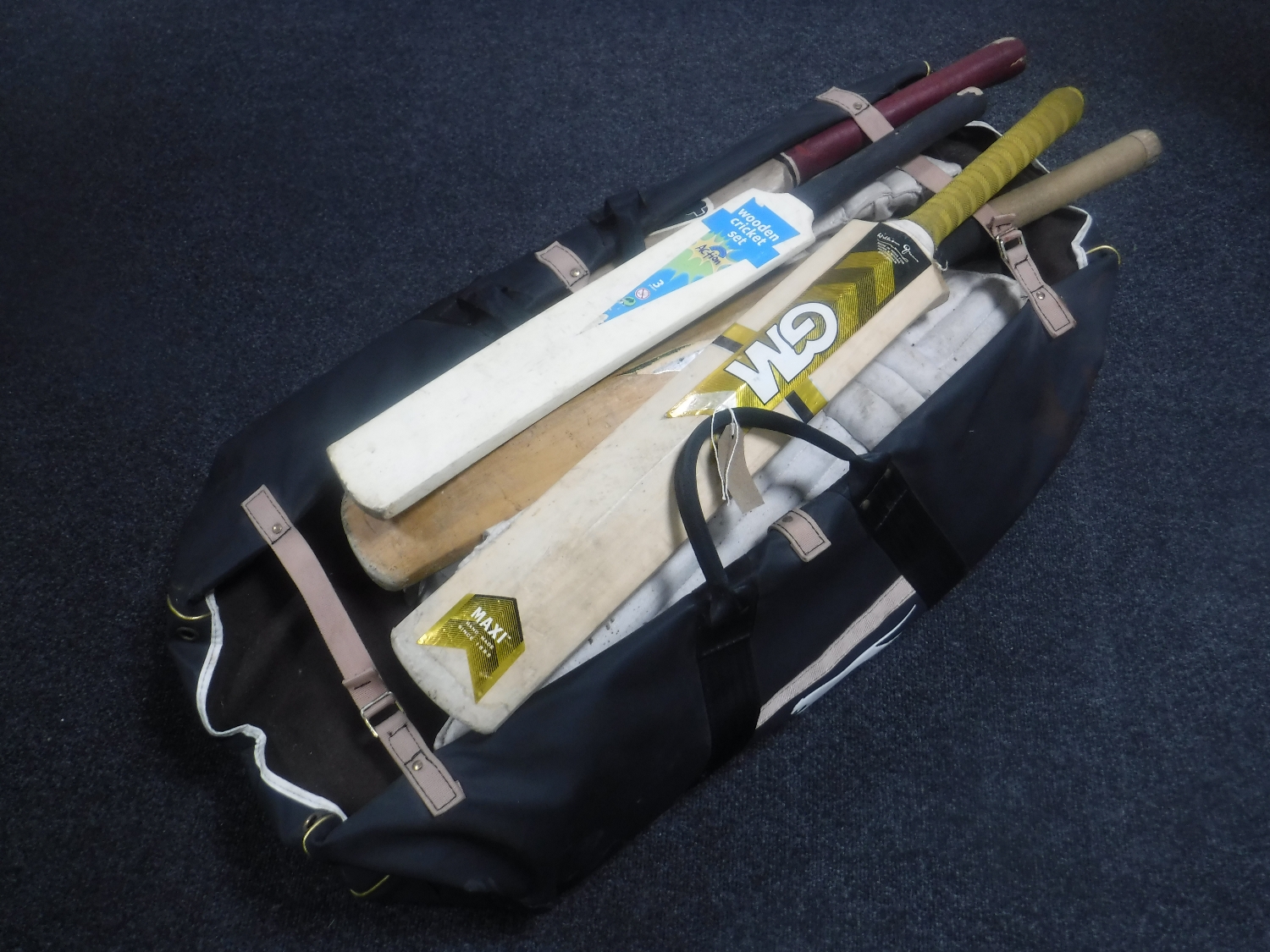 A cricket bag containing pads and bats