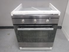 An Indesit electric wall cooker in cupboard