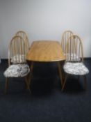 An Ercol elm drop leaf table together with four high-back chairs